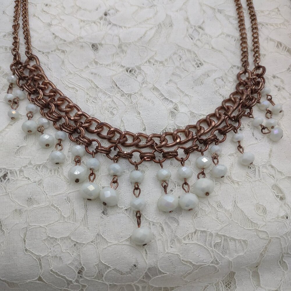 Milk glass beads necklace on chain.